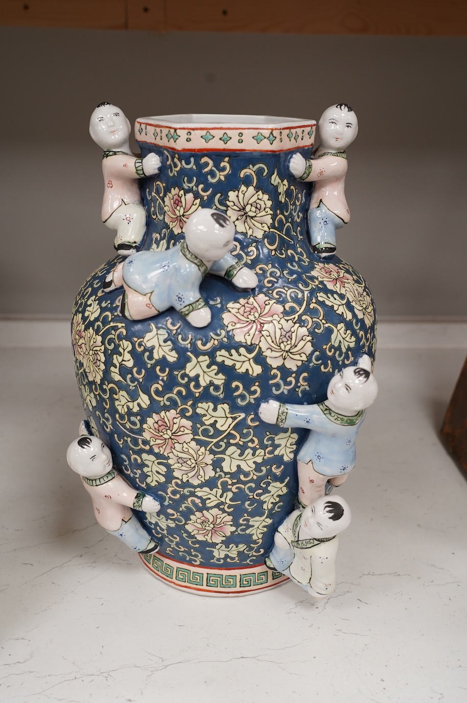 A 20th century Chinese famille rose Buddha, a ‘hundred boys’ vase and a boxed set of cloisonné boxes, vase 34cm. Condition - cloisonné boxes good, Buddha has missing decoration to robe near right hand and vase good